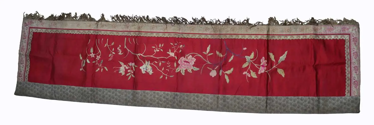 Lot 93 - A Chinese embroidered red silk floral panel