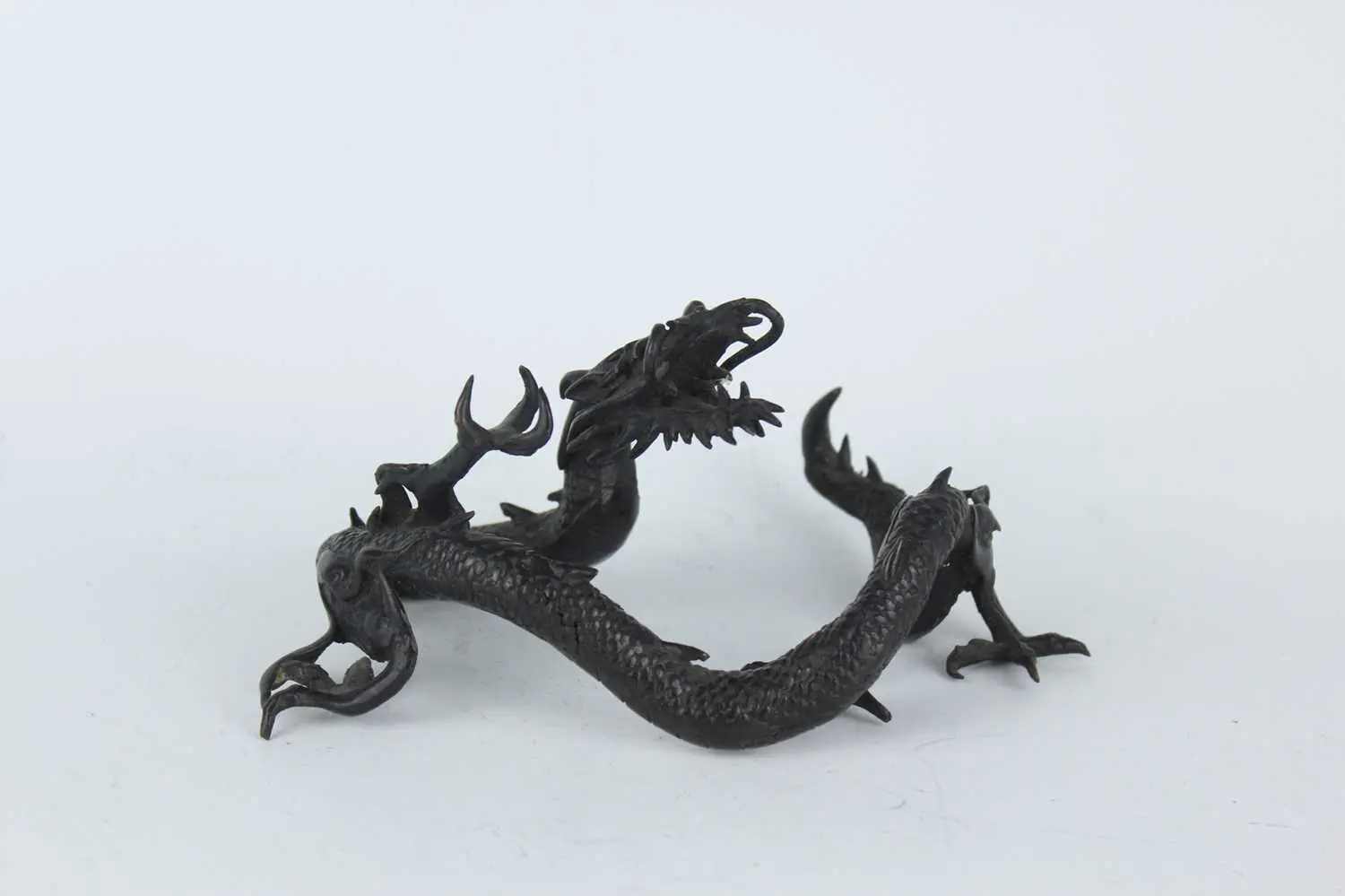 Lot 209 - A Japanese bronze okimono of a dragon, Meiji