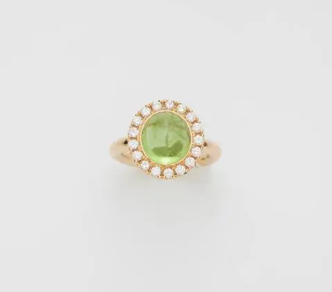 An 18k yellow gold diamond and peridot cabochon cluster ring.