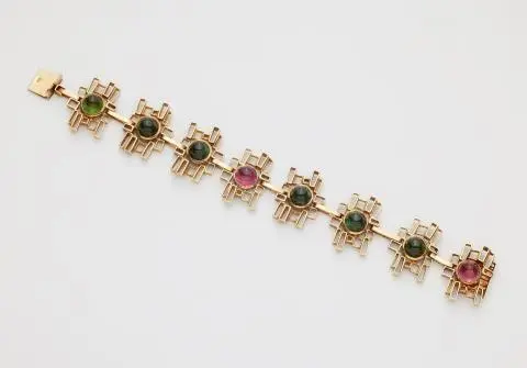 A 14k gold and sugarloaf-cut green and pink tourmaline bracelet.