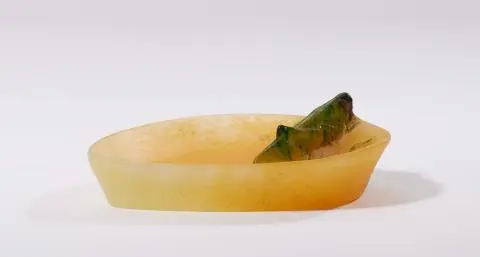 A pâte de verre glass dish with a grasshopper motif