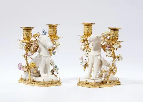 A pair of ormolu candlesticks with sitting dogs