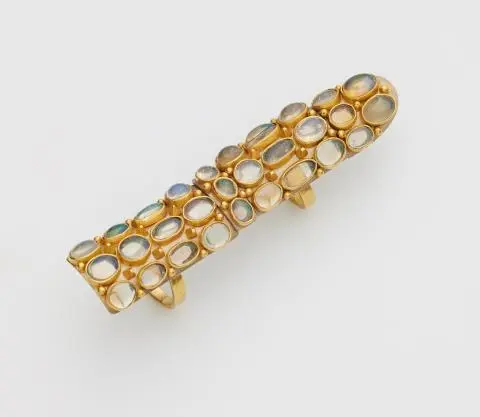A German 18k bicolour gold and opal full finger ring.