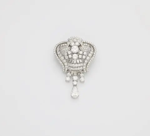 An opulent platinum and diamond cocktail brooch with pendilia.