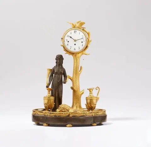 A table clock with two inkwells and a paperweight