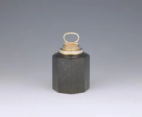 A silver-mounted serpentine canister
