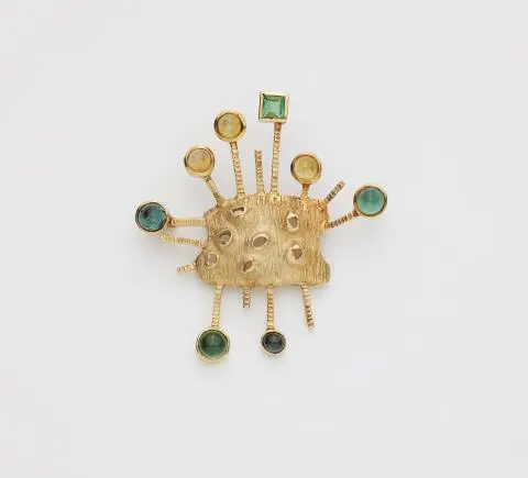 An abstract textured 14k gold tourmaline and citrine brooch.