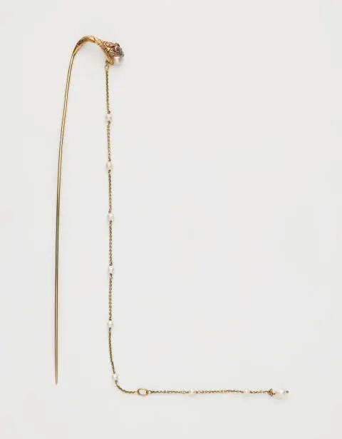 An Art Nouveau 15k yellow gold ruby and baroque pearl hat pin.
