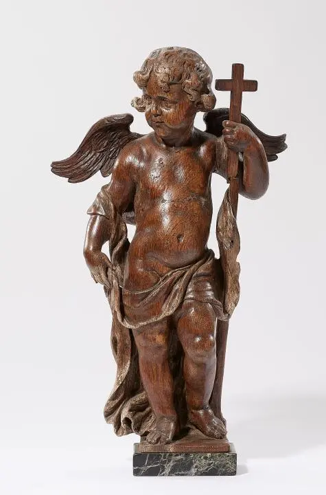 A carved oak putto as an allegory of faith