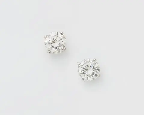 A pair of 18k white gold and brillant-cut diamond solitaire stud earrings.