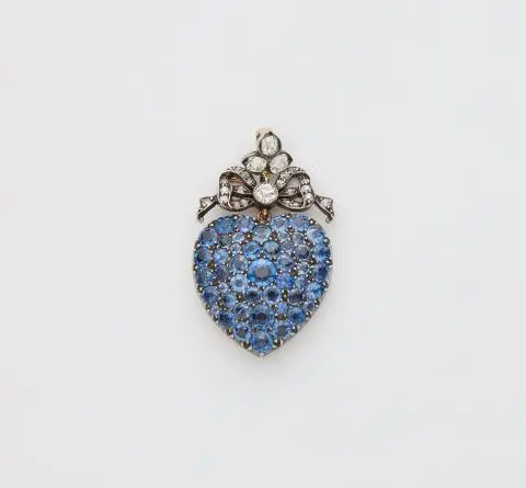 A Victorian silver 14k gold diamond and sapphire heart locket.