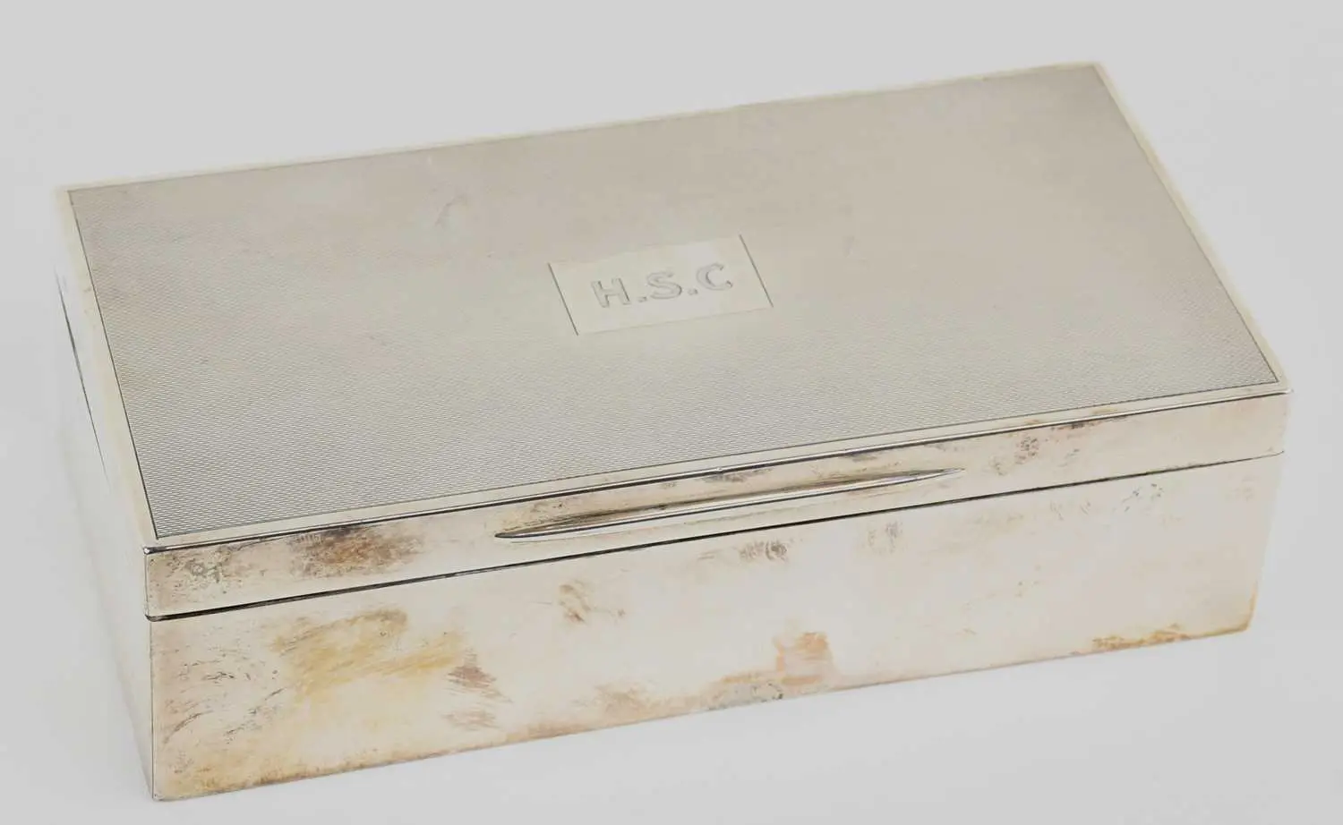 An early 20th century rectangular wood lined hallmarked silver cigarette box