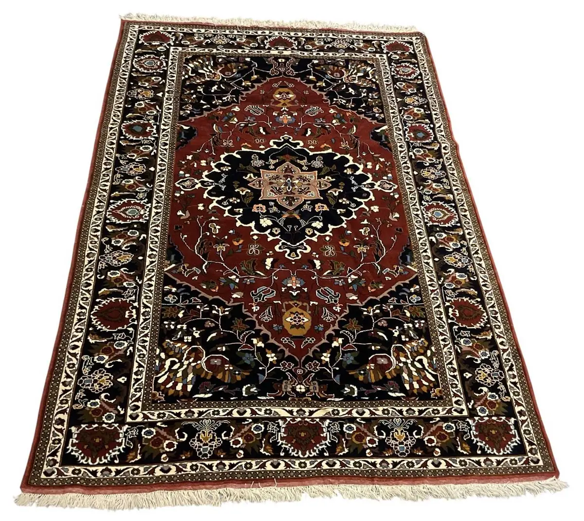 A Northeast Persian woollen red and blue ground rug