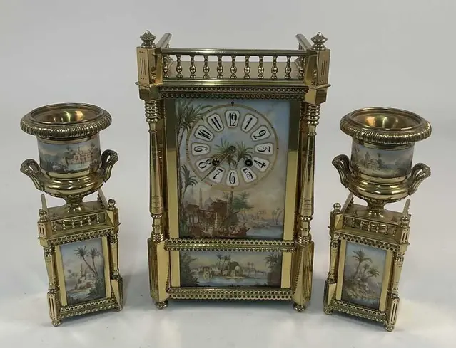 A French brass mantel clock with a Roman numeral dial set...