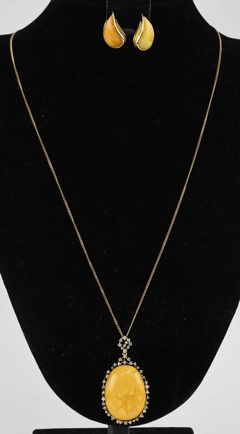 A 14ct yellow gold diamond and Lithuanian butterscotch amber set pendant