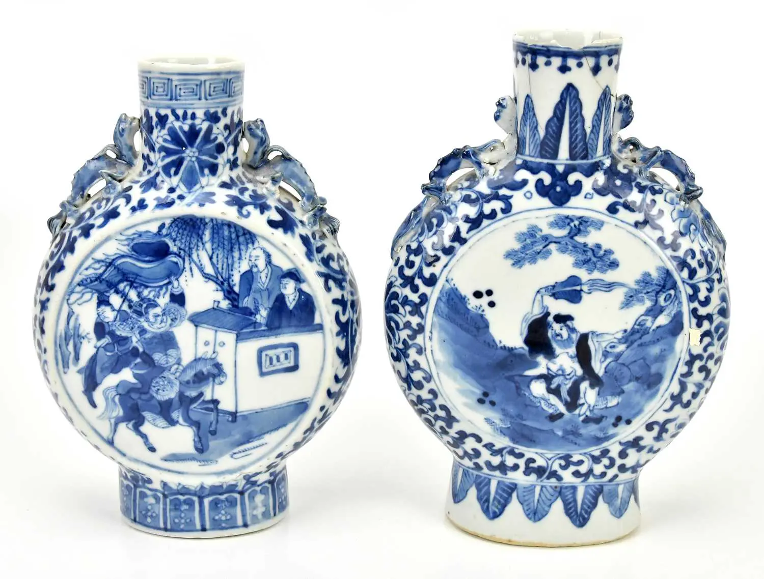 A near pair of late 19th century Chinese blue and white porcelain moon flasks