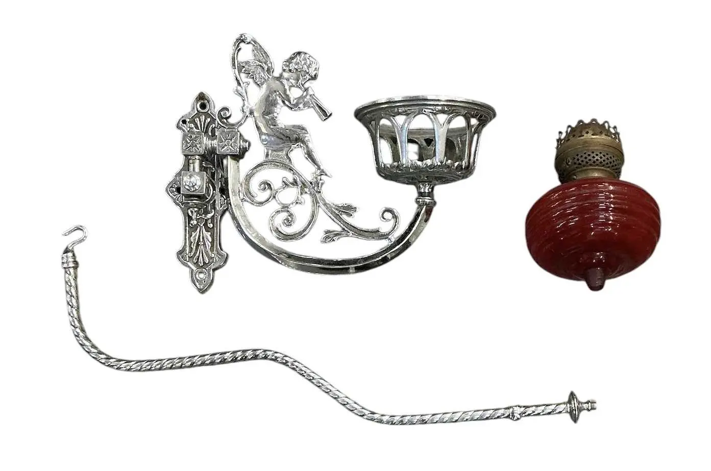 An early 20th century silvered metal wall mounted oil lamp