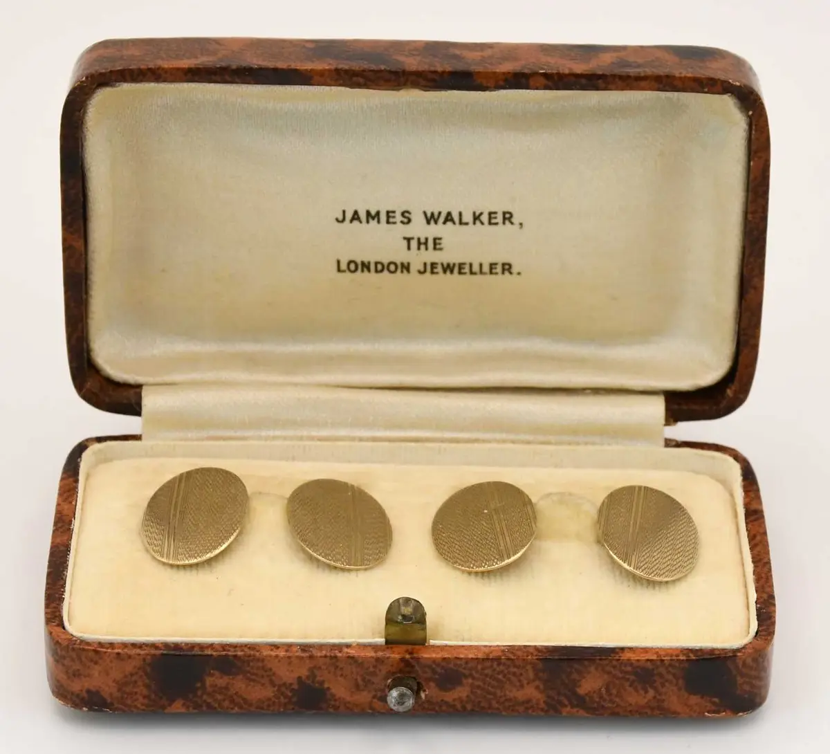 A pair of 9ct yellow gold engine turned oval cufflinks