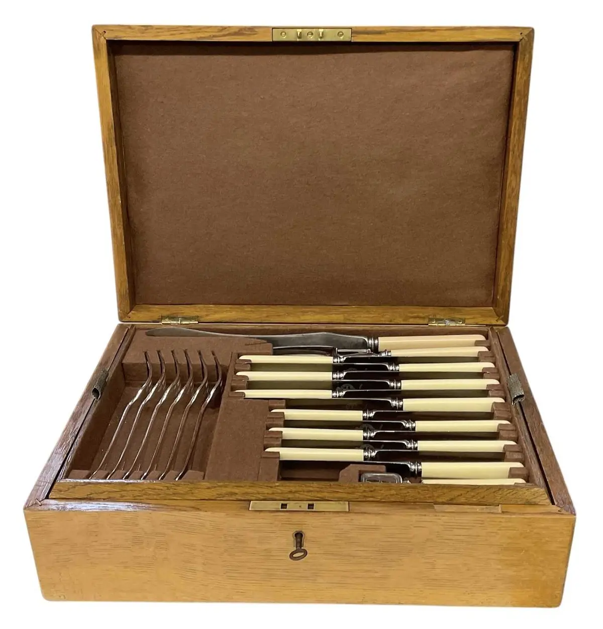 An early 20th century light oak cased six setting canteen...