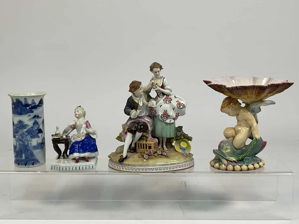 A 19th century majolica figural dish depicting a putti...