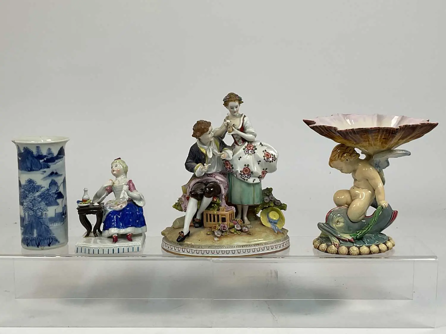 A 19th century majolica figural dish depicting a putti...