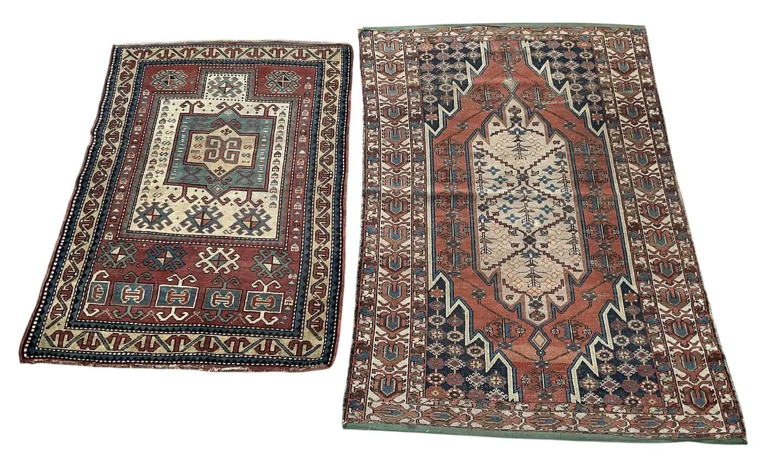 Two vintage hand woven Persian style red ground carpets