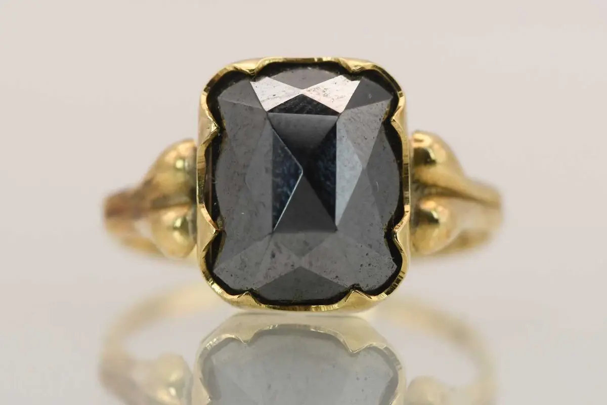 A 14ct yellow gold dress ring with cut hematite set table