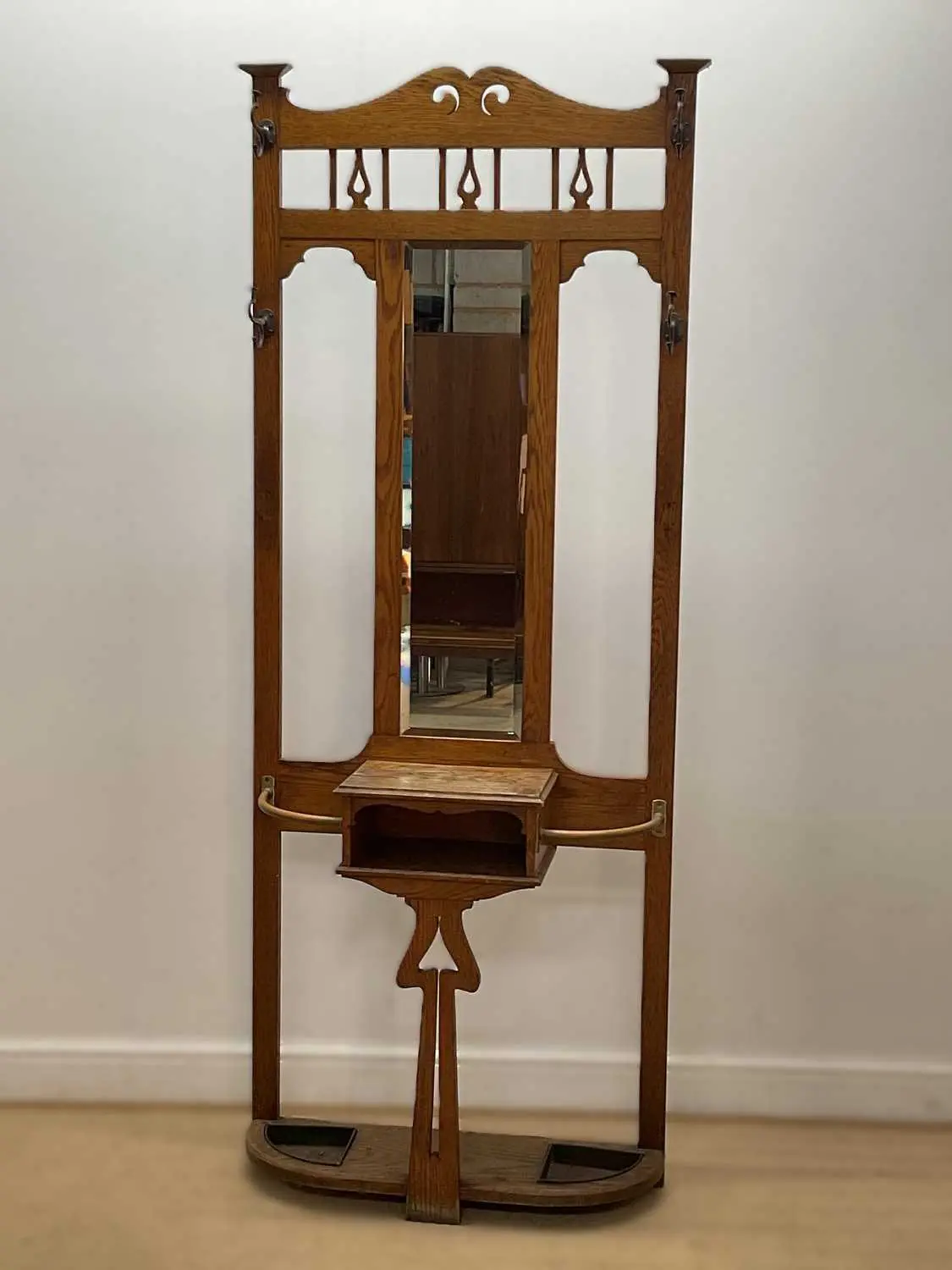 An Art Nouveau oak hall stand with central mirror