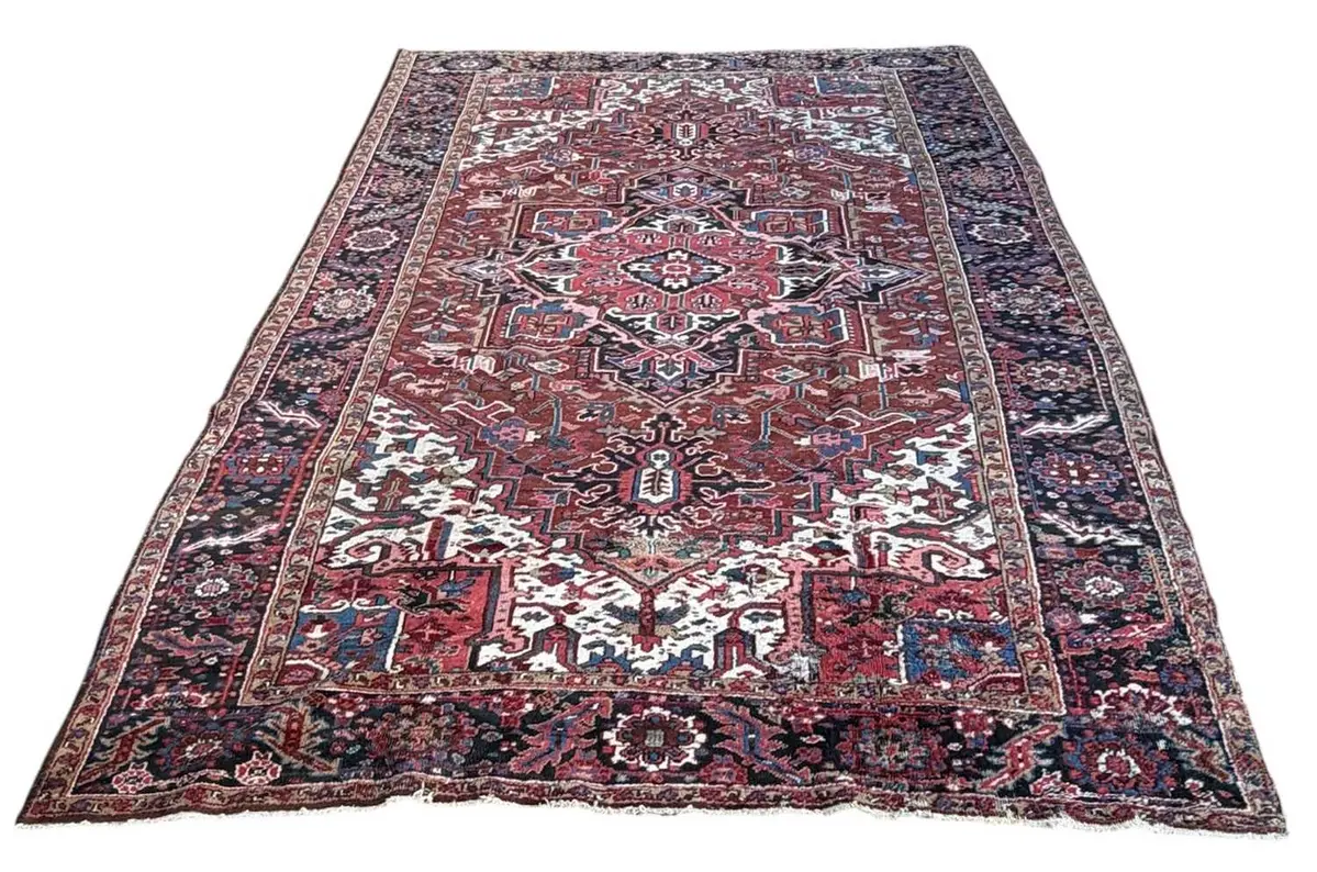 A Persian red ground Heriz carpet