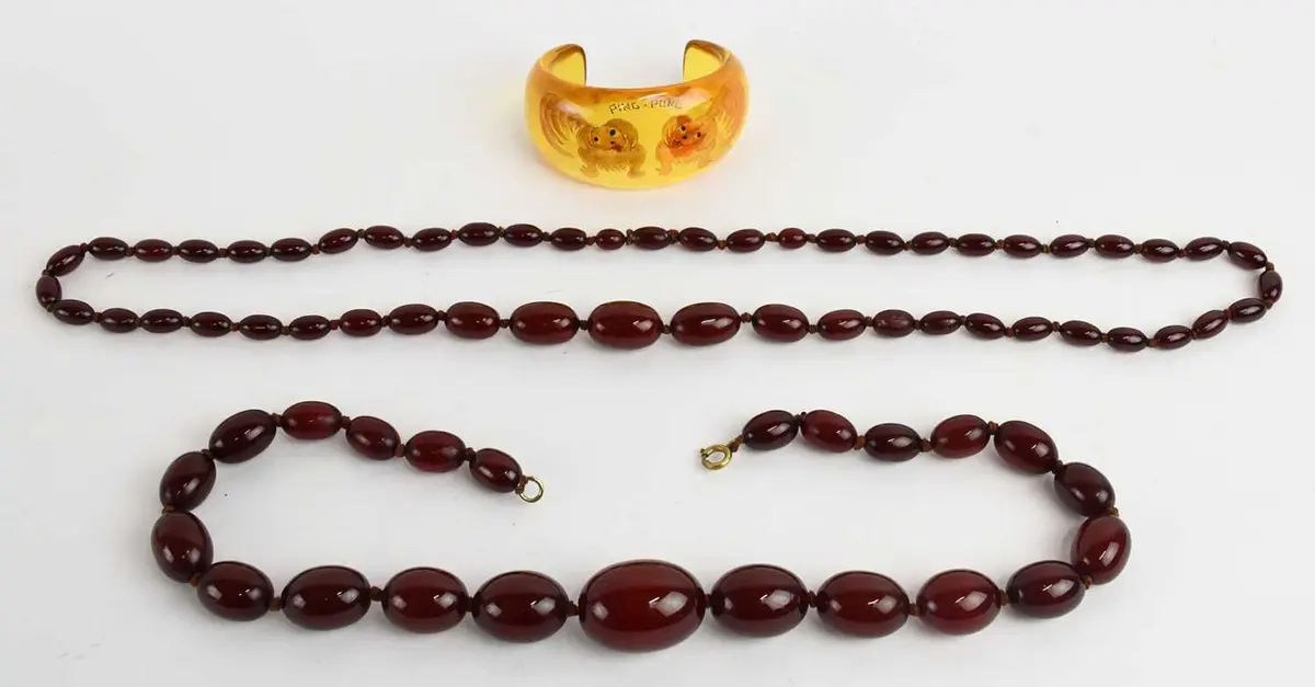 Two 1930s Art Deco cherry bakelite amber single strand bead necklaces