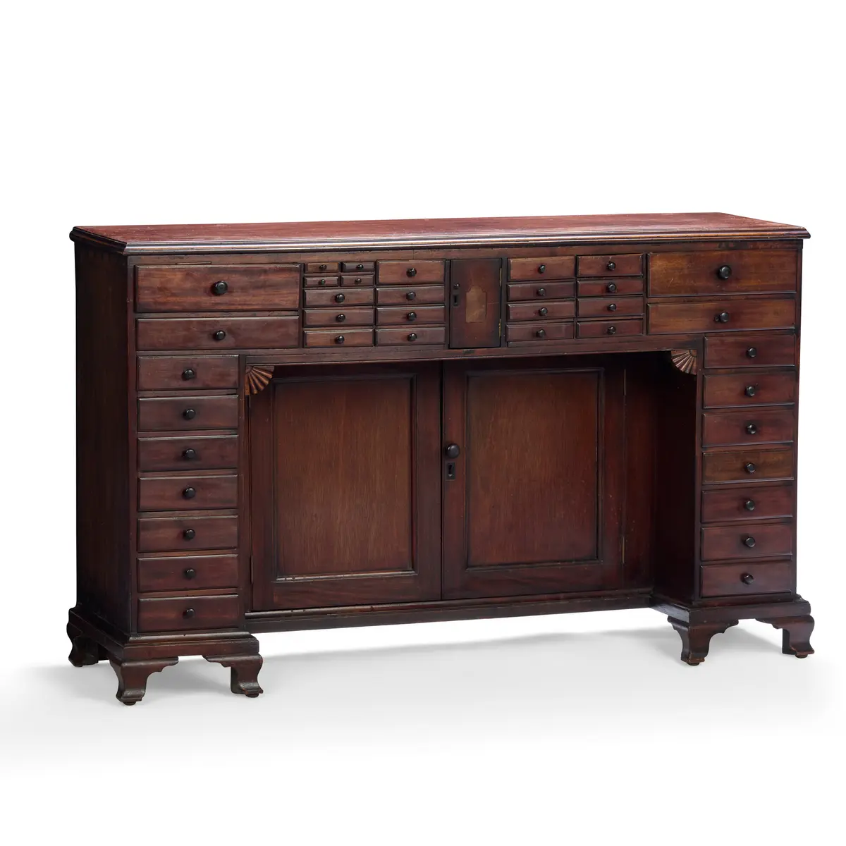 LATE REGENCY MAHOGANY KNEEHOLE COLLECTOR'S CABINET