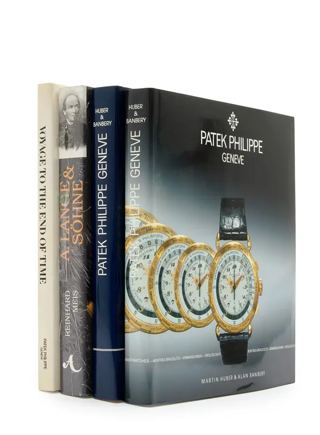 A group of 4 watch books