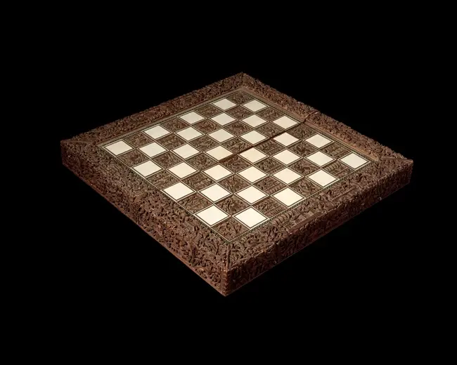A deeply carved sandalwood and sadeli ware chessboard