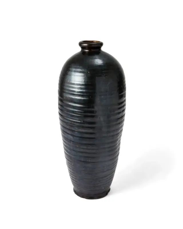 A large Chinese ribbed black glazed baluster vase