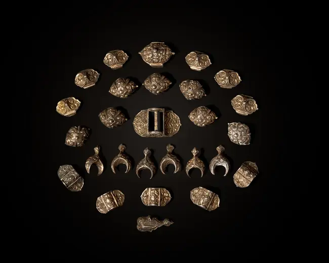 A group of gilt silver repoussé belt mounts