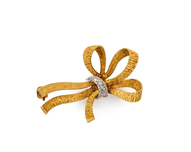 An 18ct gold diamond set bow brooch