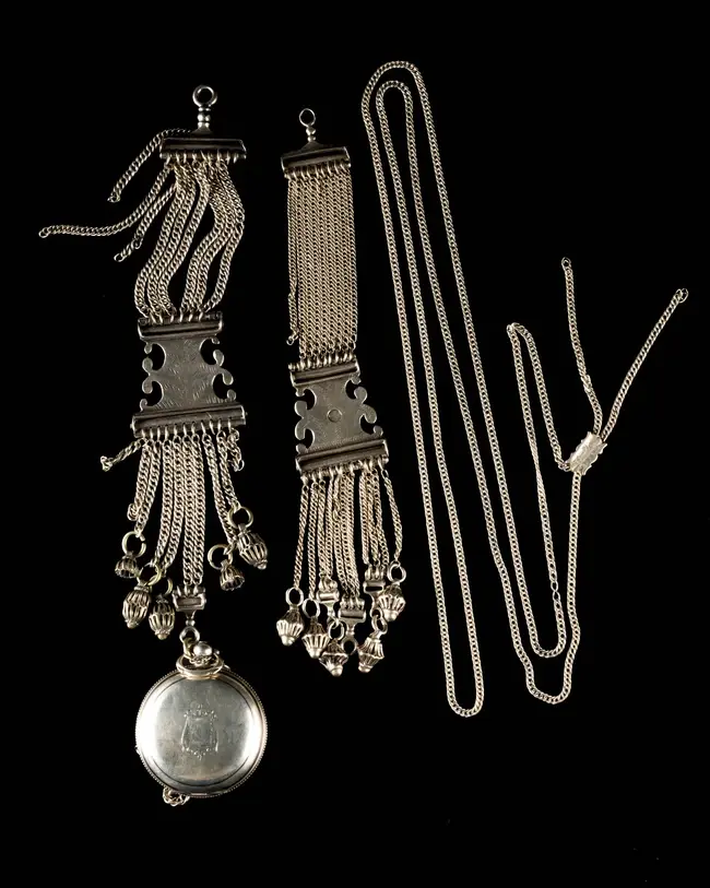A silver cased pocket watch and attachment chain