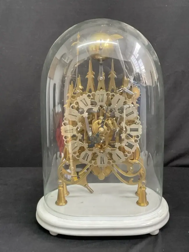 A C19th English glass domed brass triple fusée gothic skeleton clock