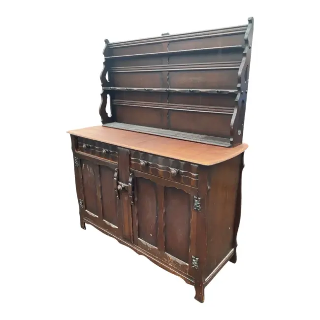 An oak dresser with delft rack having three plate shelves and pegs