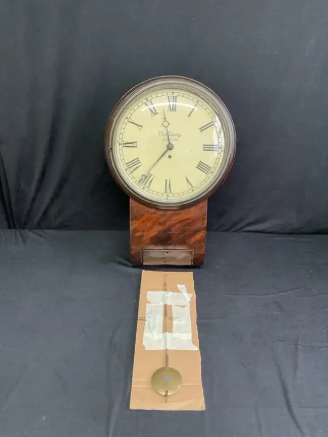 A Victorian mahogany drop-dial clock with circular moulded face under
