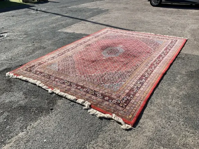 A Tabriz wool carpet with hexagonal medallion amid a dense flowerhead