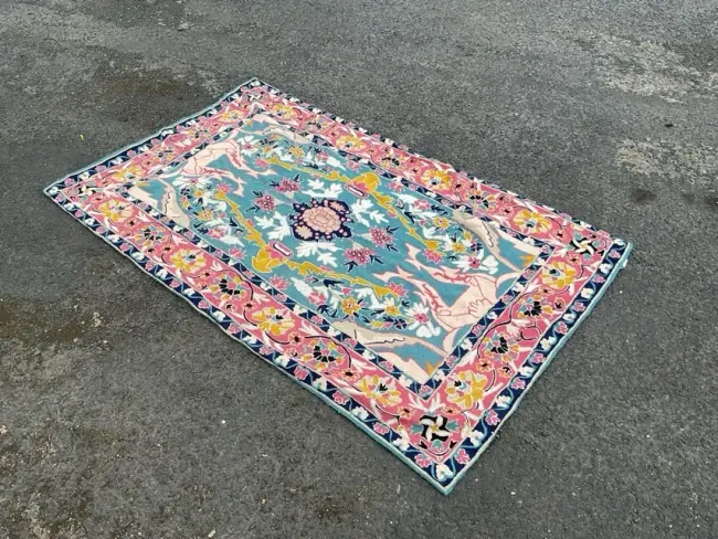 A Kashmiri chainstitch embroidered rug worked in wools on cotton canvas