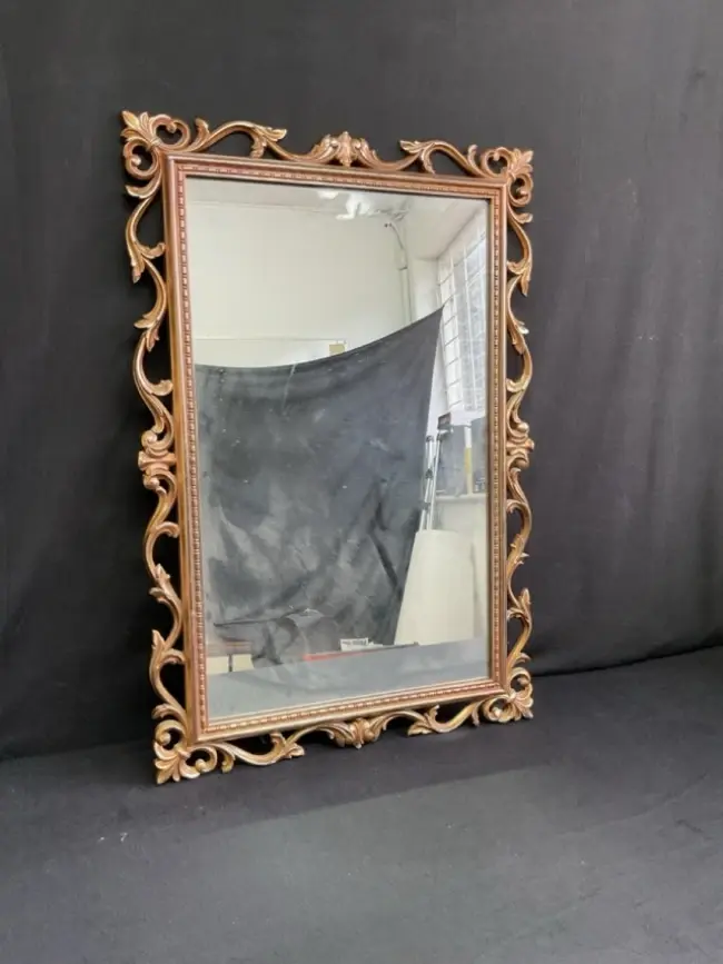 A Georgian style rectangular mirror with rococo pierced foliate scroll