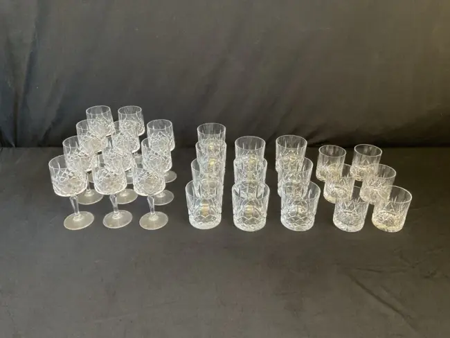 A set of cut crystal wine glasses and matching tumblers; and a similar