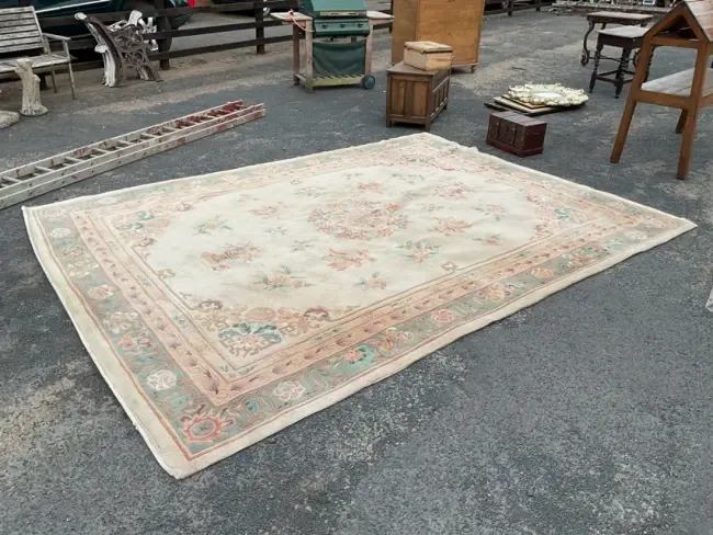 A Chinese wool carpet with central Chou medallion amid scattered flower