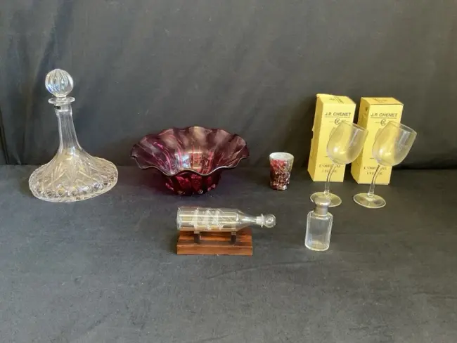 A Thomas Webb cut crystal ships decanter; a cranberry studio glass