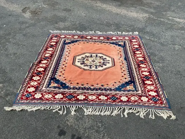 A Turkish wool carpet woven with octagonal stylised floral medallion