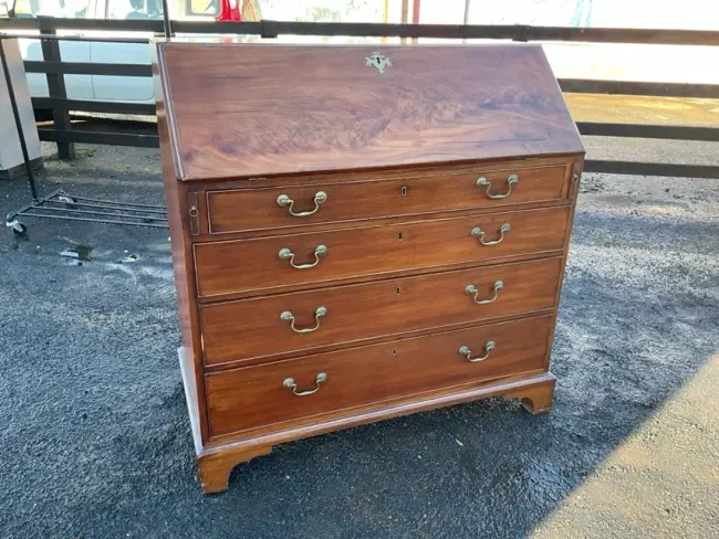 A George III mahogany bureau having fitted interior with pigeonholes
