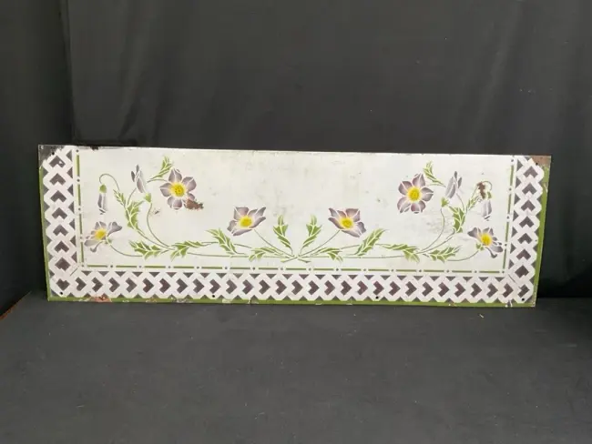 A French art nouveau enamelled metal splashback with stencilled decoration
