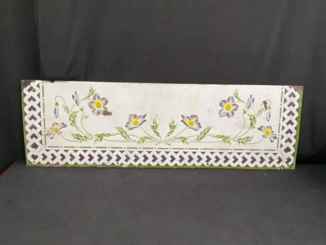 A French art nouveau enamelled metal splashback with stencilled decoration